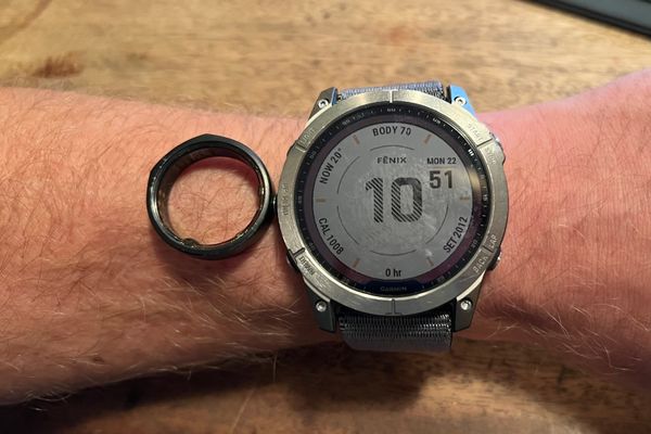 A Garmin Fenix 7x on a wrist by an Ōura ring 