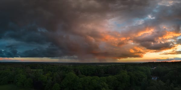 A midsummer rain squall over Oxfordshire at sunset.